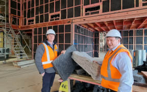Signal Management Construction Manager Nick Jones (left) and Facilities Administration Officer Neil Mair with samples of the wool-blend product being installed in the Gore District Council’s new community centre and library.