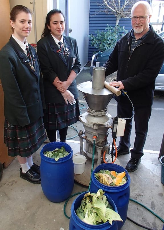 Kaika Energy's sales director Paige Gilder (left), operations director Deanna Teremoana (centre) and technical advisor Peter Dodds (right) with the macerator and buckets of food waste ready to be processed.