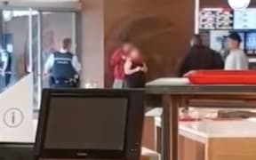 Police spent almost 40 minutes negotiating with a man who held a knife to the throat of a woman he did not know in a mall in South Auckland this morning.