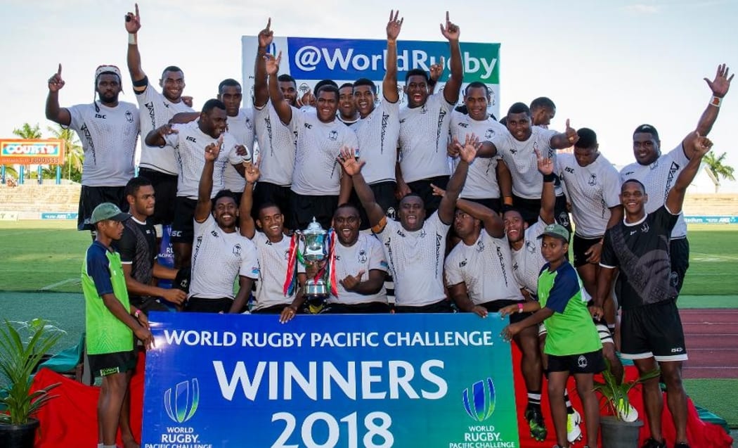 The Fiji Warriors celebrate with the trophy.