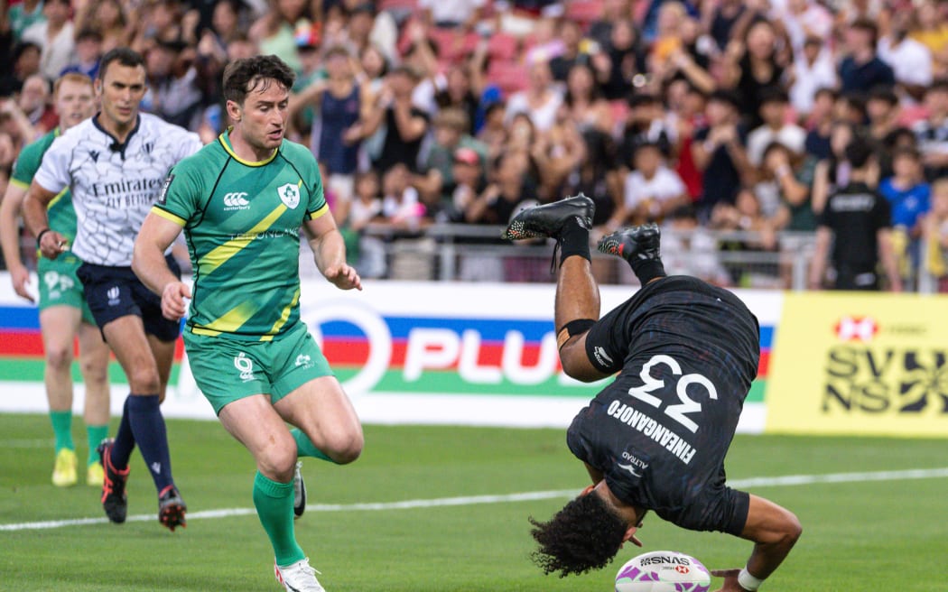 New Zealand's Fehi Fineanganofo scores a try performing a flip as he scores. Singapore Sevens, 2024.