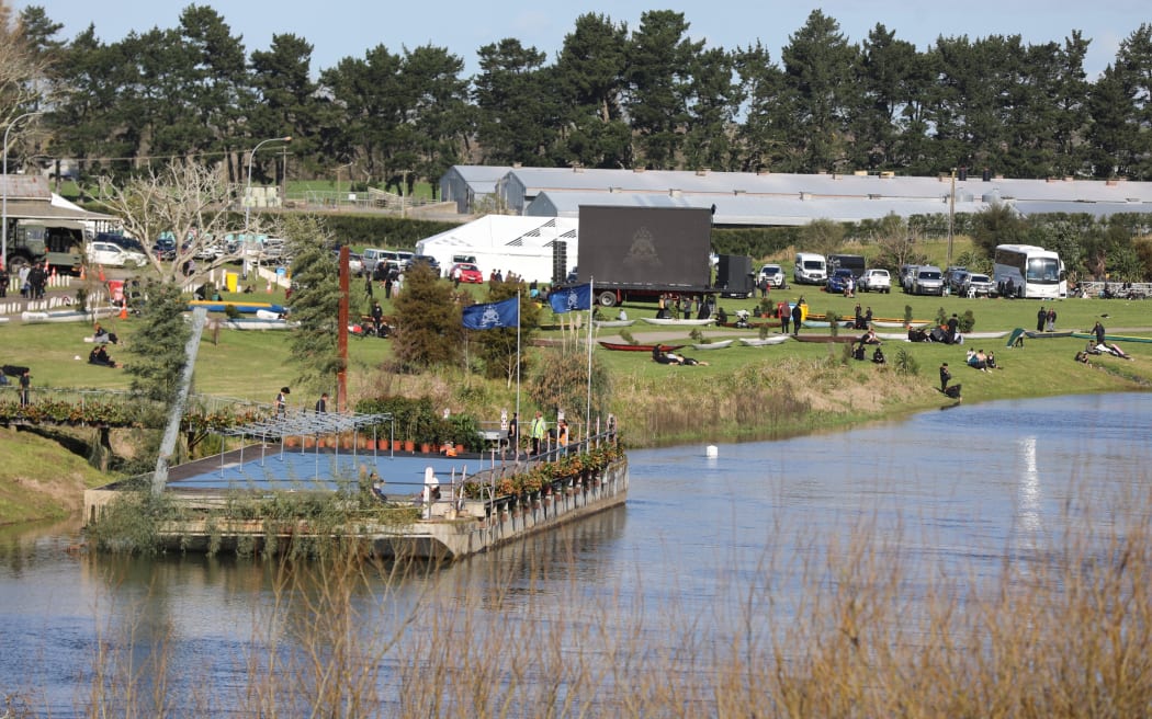 Waka and other boats pulled up alongside the Waikato River, before the procession taking Kiingi Tuheitia to his final resting place on Taupiri.