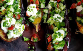 Eggplant with cucumber and tomato salad by Julie Biuso.
