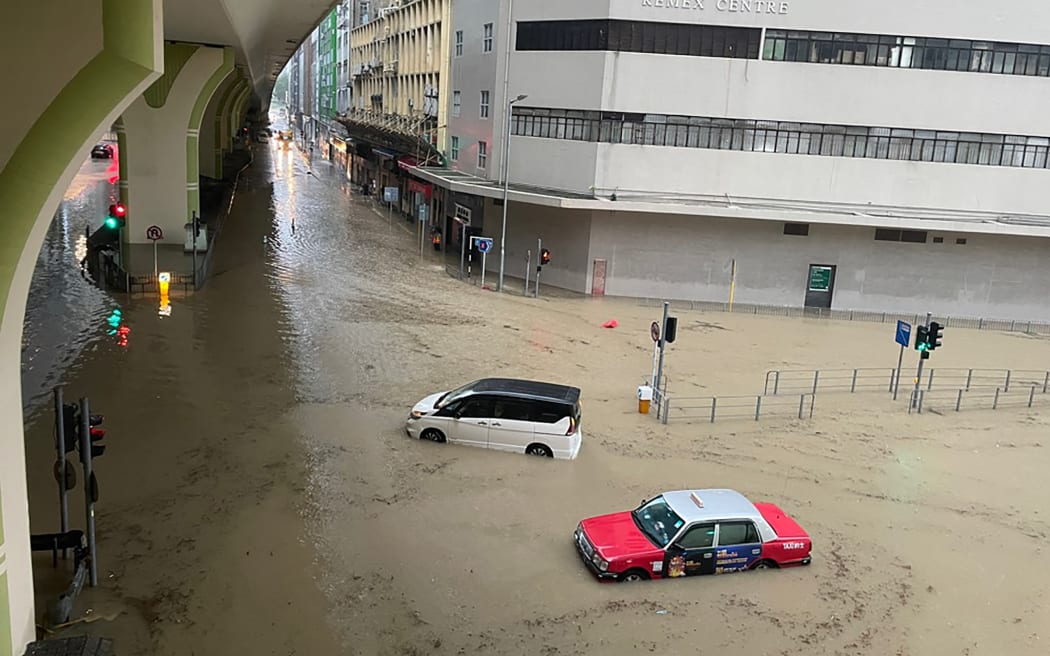 This picture shows stranded vehicles on a flooded road in Hong Kong on September 8, 2023. Record rainfall in Hong Kong caused widespread flooding in the early hours on September 8, disrupting road and rail traffic just days after the city dodged major damage from a super typhoon. (Photo by Libby HOGAN / AFP) / “The erroneous mention[s] appearing in the metadata of this photo by Libby HOGAN has been modified in AFP systems in the following manner: [stranded vehicles on a flooded road] instead of [commutes on a flooded road]. Please immediately remove the erroneous mention[s] from all your online services and delete it (them) from your servers. If you have been authorized by AFP to distribute it (them) to third parties, please ensure that the same actions are carried out by them. Failure to promptly comply with these instructions will entail liability on your part for any continued or...