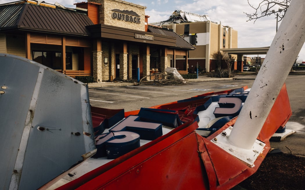 FULTONDALE, AL- JANUARY 26: A restaurant sign lies on the ground after sustaining damage from a tornado on January 26, 2021 in Fultondale, Alabama. A tornado ripped through Fultondale damaging property and leaving one person dead and more than a dozen injured.