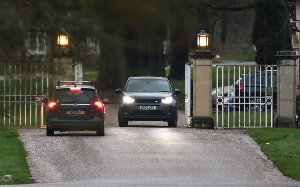 Cars are pictured at the entrance to the Royal Lodge, a 30-room property and former residence to Britain's former prince Andrew, at Windsor Great Park in Windsor, Berkshire on February 19, 2026, which was reportedly searched by police while Andrew was arrested earlier in the day at the king's private Sandringham estate in Norfolk. Britain's royal family was in crisis on February 19 as former prince Andrew was in police custody after being arrested on suspicion of misconduct for his links to late US sex offender Jeffrey Epstein. (Photo by Toby Shepheard / AFP)