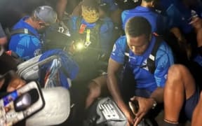 Fijian Drua waiting to get a lift to their hotel in Auckland late at night.