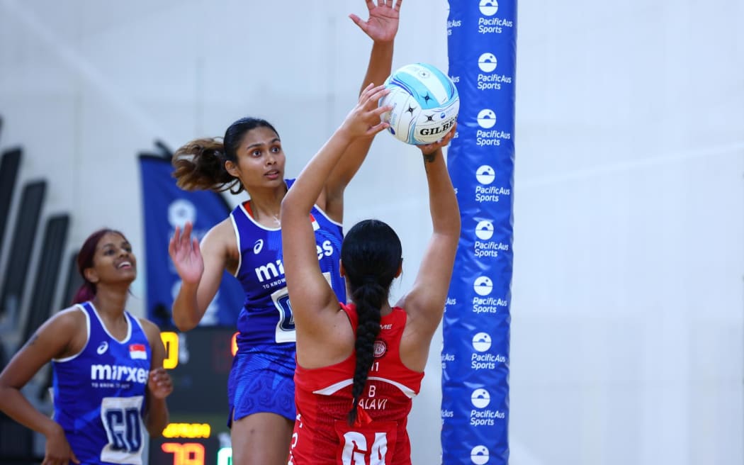 Defending champs Tonga Tala (red) thrash Singapore 85-40 to open their account on the Gold Coast.