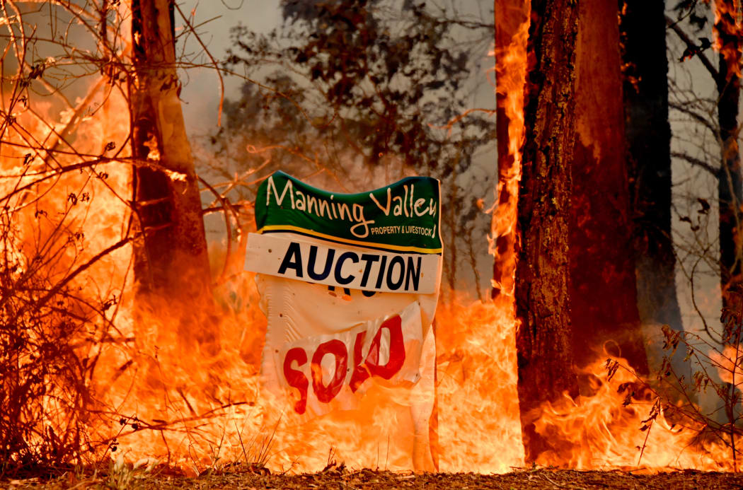 A bushfire burns outside a property near Taree, 350km north of Sydney on November 12, 2019.