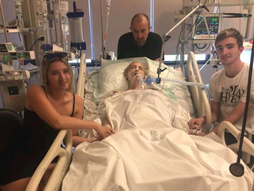 New Zealand mother Abby Hartley in a Bali Hospital with her children, Sophie and Toby, and husband, Richard.