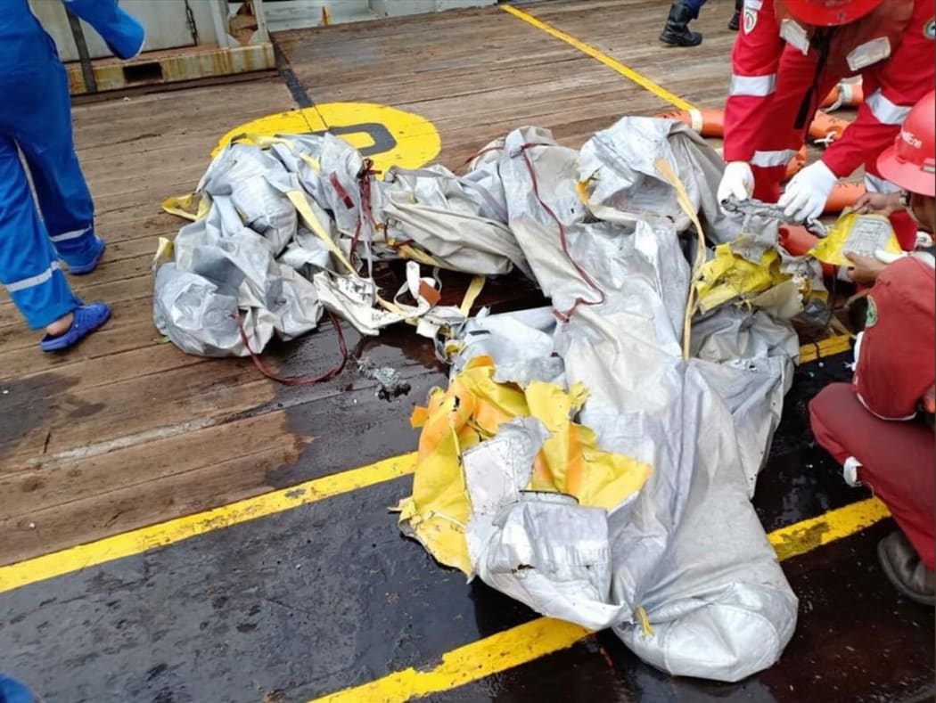 Personnel looking at items believed to be from the wreckage of the Lion Air flight JT 610, recovered off the coast of Indonesia's Java island after the Boeing crashed into the sea.
