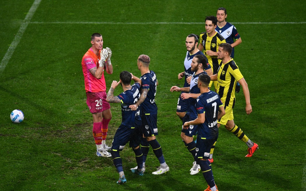 Jake Brimmer of Melbourne Victory (2nd left) reacts after scoring a goal from a penalty shot during the A-League men’s soccer match between Melbourne Victory and Wellington Phoenix.