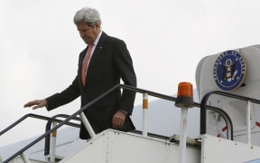 US Secretary of State John Kerry disembarks from his aircraft in a surprise visit to Afghanistan.