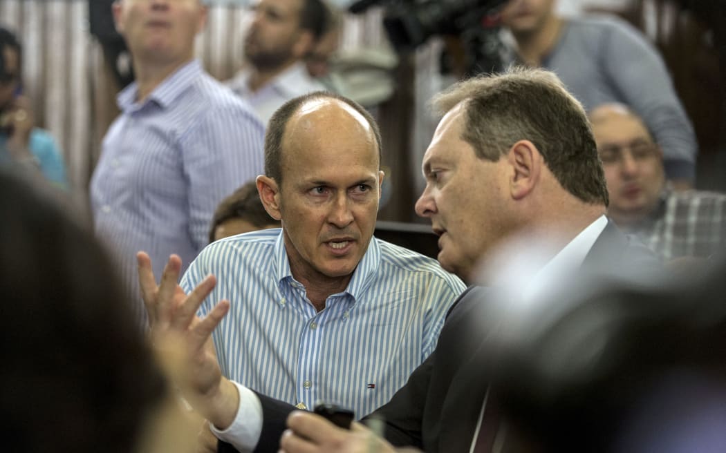 Peter Greste's brother Andrew (centre) and Australia's ambassador to Egypt Ralph King (right) during the trial.