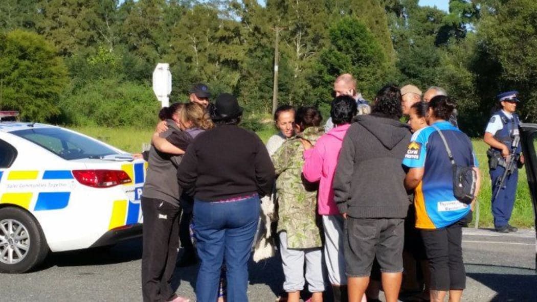 Family of the alleged gunman near the police cordon