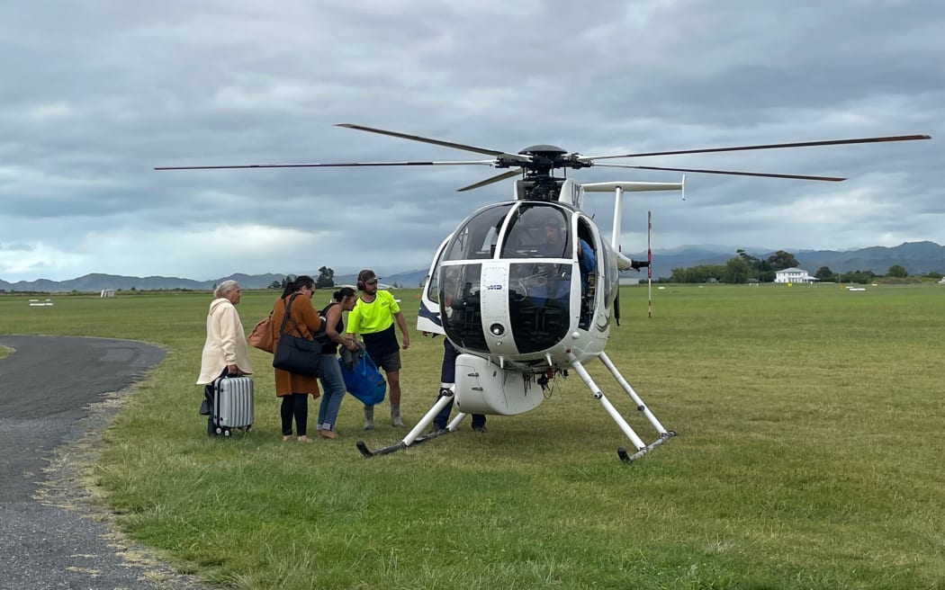 Residents stuck in Gisborne board a chopper to Tokomaru Bay on 16 February 2023 after Cyclone Gabrielle.
