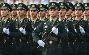 Chinese soldiers take part in a rehearsal hours before a military parade marking the 80th anniversary of victory over Japan and the end of World War II, in Beijing’s Tiananmen Square on 3 September, 2025.