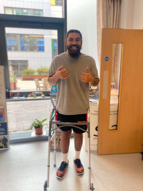 Mose Masoe standing and walking for the first time after his injury.