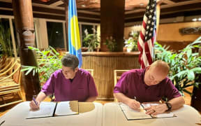 Palau’s President Surangel Whipps (left) and United States Navy Rear Adm. Michael Day are pictured signing a maritime law enforcement agreement in Koror, Palau on Aug. 23, 2023.
