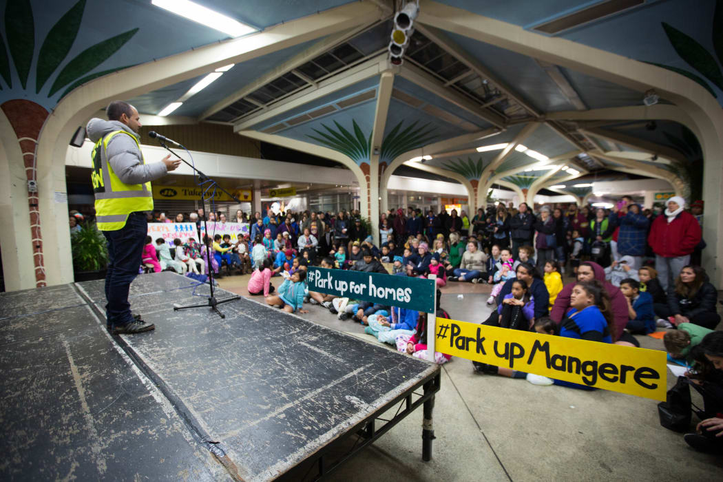 Justin Latif, #parkupforhomes organiser, speaks to people who have come to the event at Mangere Town Centre.