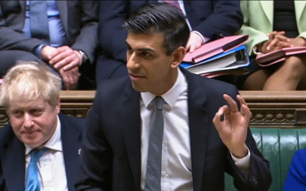 A video grab from footage broadcast by the UK Parliament's Parliamentary Recording Unit (PRU) shows Britain's Chancellor of the Exchequer Rishi Sunak gesturing as he presents the Spring budget statement to MPs.