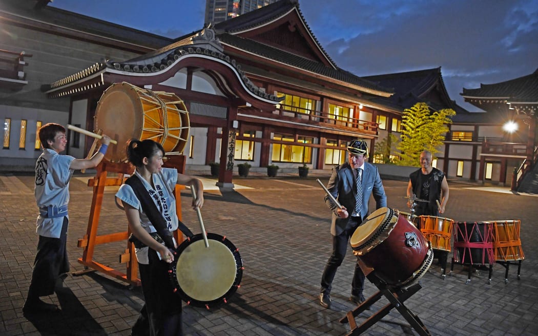 All Black Brad Webber plays drums after a welcome ceremony at Zojoji temple in Tokyo on September 14, 2019.