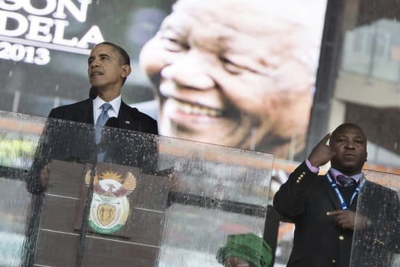 Interpreter Thamsanqa Dyantyi on stage with US President Barack Obama.
