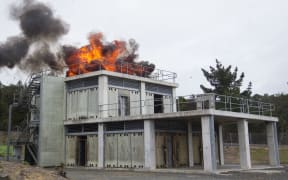 An explosion is set off to mark the opening of the SAS' new training facility in Papakura, Auckland.