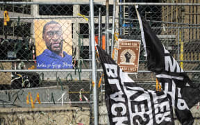 A portrait of George Floyd hangs on the fencing outside the Hennepin County Government Center on April 1, 2021 in Minneapolis, Minnesota.
