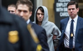 Law enforcemement officers arrest Martin Shkreli, centre, in New York.