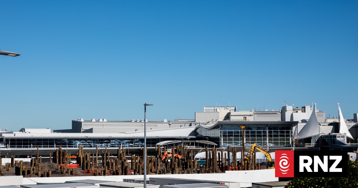 A large industrial building complex under a clear blue sky.