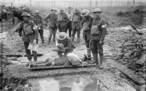 A wounded NZ soldier on a stretcher in Belgium, late 1917.