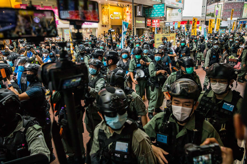 Riot police clear a street as protesters gathered to rally against a new national security law in Hong Kong on July 1, 2020, on the 23rd anniversary of the city's handover from Britain to China.