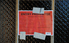 A red sticker on the front door of a property damaged in Saturday’s tornado in Papatoetoe’s Hayward Rd.