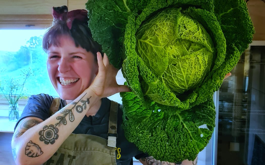Head Chef Niccola Mudge with a cabbage from the market garden at Fat Pig Farm