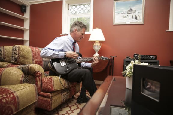 Scott Brown, US Ambassador to New Zealand at his Lower Hutt home plays guitar for media.