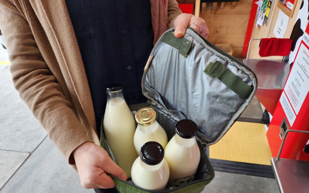 A customer collects a week's worth of milk from Faith Farm Fresh