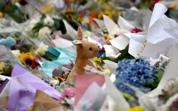 Tributes from mourners are piled together at the Bondi Pavilion in memory of the victims of a shooting at Bondi Beach, in Sydney on December 16, 2025. Australia's leaders have agreed to toughen gun laws after attackers killed 15 people at a Jewish festival on Bondi Beach, the worst mass shooting in decades decried as antisemitic "terrorism" by authorities. (Photo by Saeed KHAN / AFP)