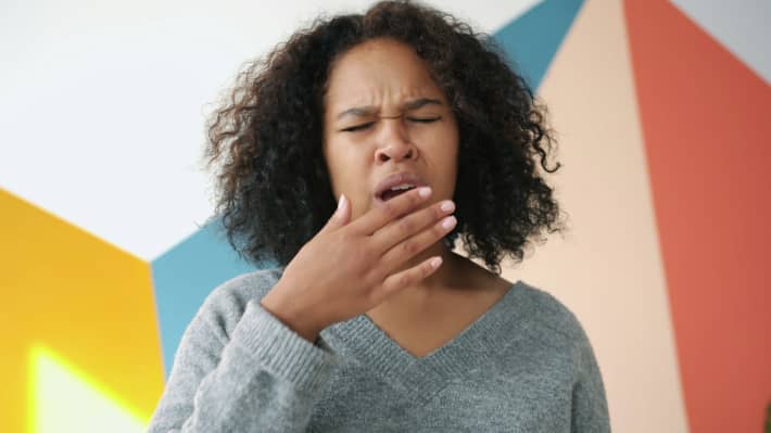Tired woman yawning