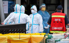 Members of the Melbourne Fire Brigade (MFB) prepare to take food parcels to residents in a locked down public housing estate in Melbourne on 9 July, 2020 as the city re-enters a city wide lockdown after a fresh outbreak of the Covid-19 coronavirus.`