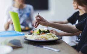 Close up family eating at dining table. (Photo by Paul Bradbury/Caia image/SCIENCE / NEW / Science Photo Library via AFP)
