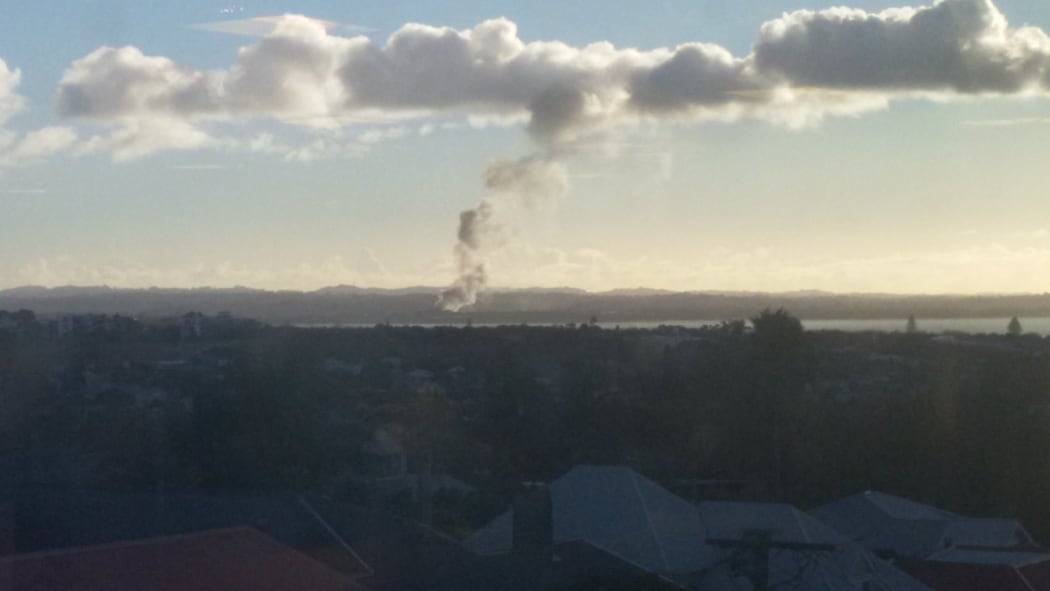 Smoke can be seen rising from the area of the Waitakere Refuse and Recycling Centre in Henderson.