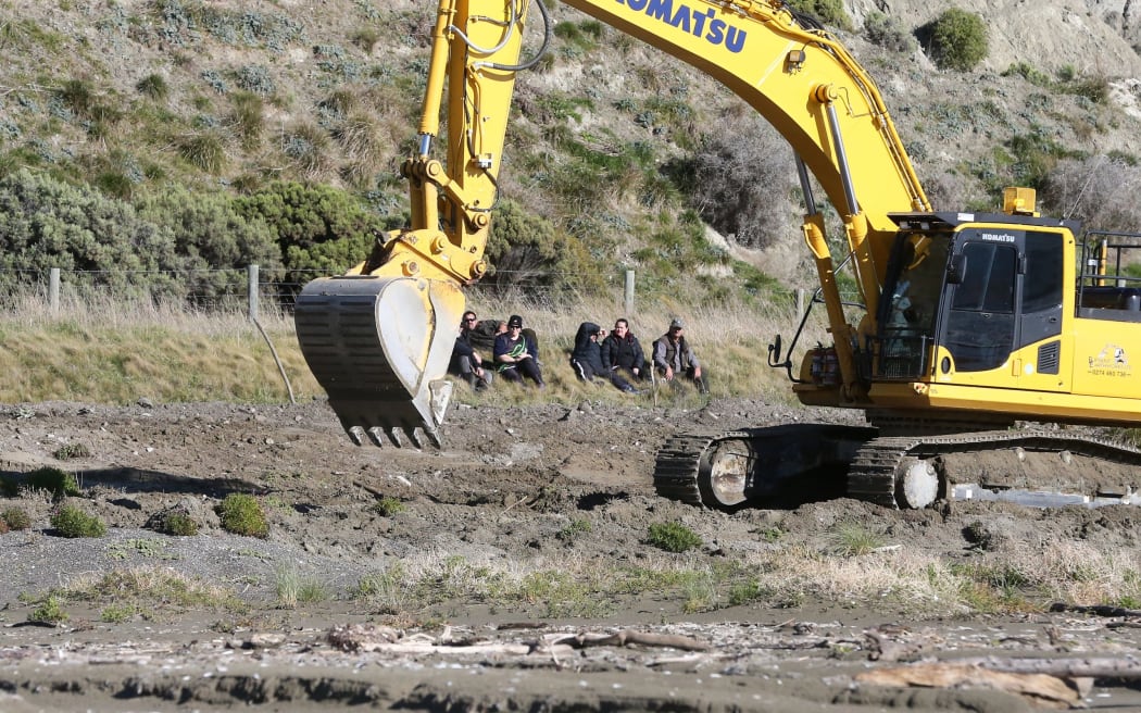 The sperm whale that was washed up on Marfells Beach is buried as iwi members watch on. SUPPLIED: STUFF - SINGLE USE ONLY