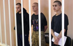 Britons Aiden Aslin and Shaun Pinner and Moroccan Saadun Brahim at a court hearing in Donetsk.