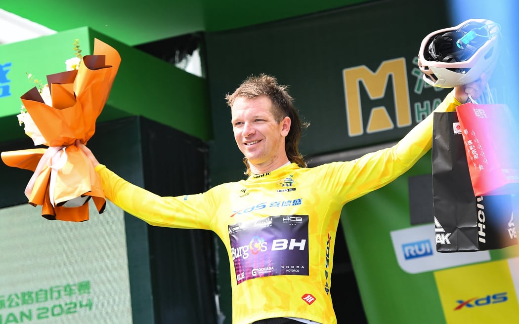 New Zealand's Aaron Gate of Burgos-BH celebrates in the yellow jersey after Stage 5 of the 15th Tour of Hainan, China 2024.