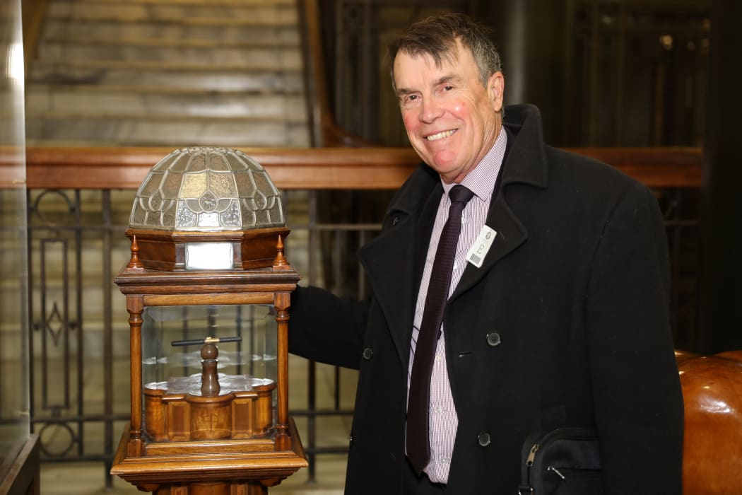Historian Ian McGibbon with the Versailles Pen in its special wood and leadlighted glass display stand.