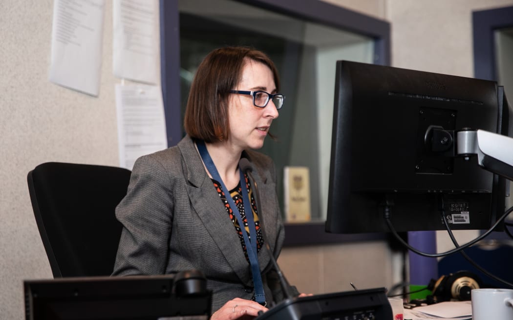 A woman sitting at a computer.