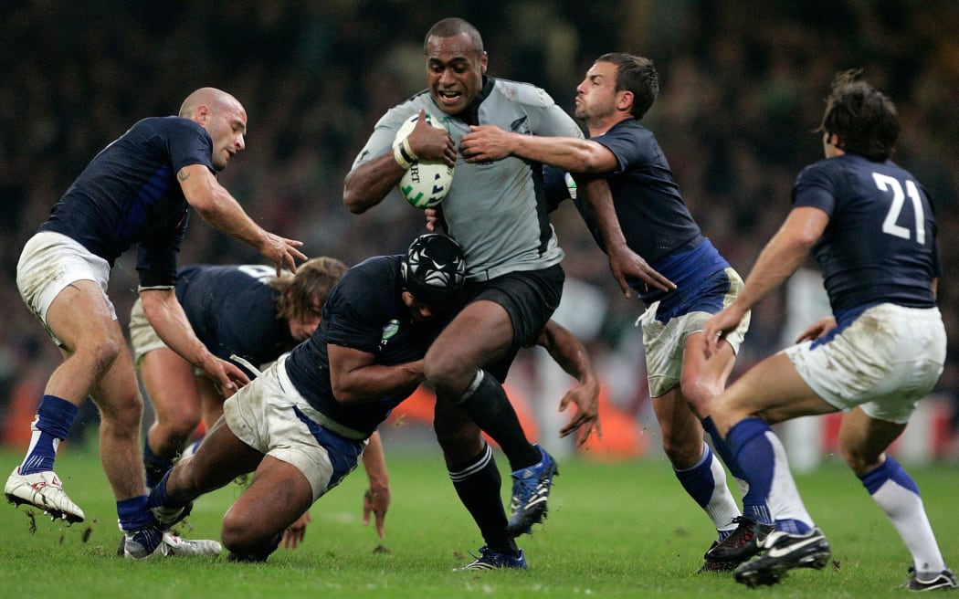 All Blacks wing Sitiveni Sivivatu is swamped by the desperate French defence in 2007