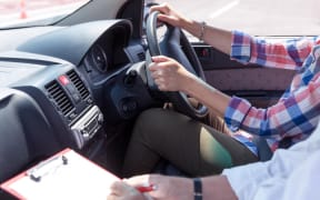 Learning to drive a car with instructor. Driving school.
