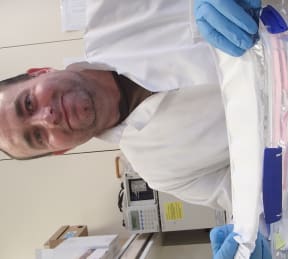 Pharmacist Greg Walker holds experimental nano-fibre wound dressings, that have been created using electro-spinning and contain polyphenols produced from wine waste.